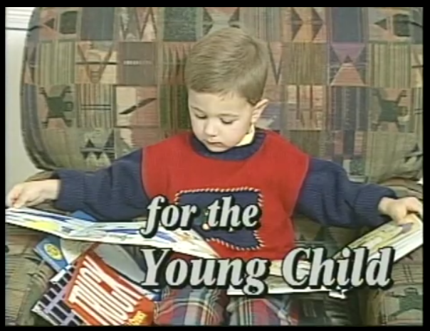 A young child is holding onto some pencils