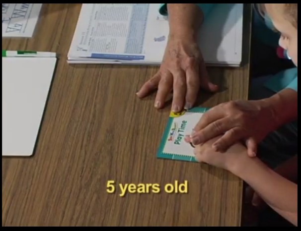 A person is holding a card on the table